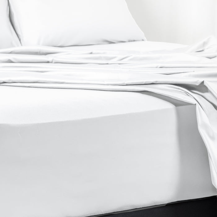 Premium Touch Bed Linens 4 Piece Flat Sheet Set in white, shown in a room setting