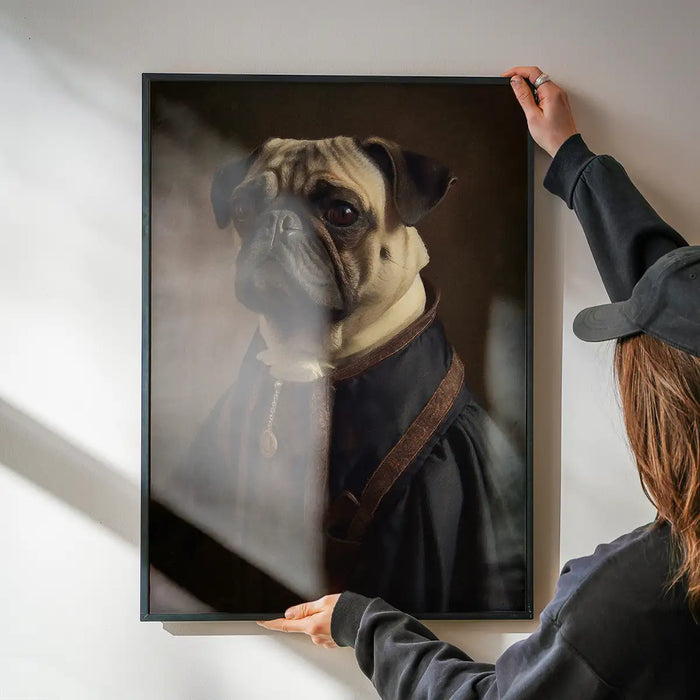 Pug Dog Portrait Print being hung on a wall in a black frame